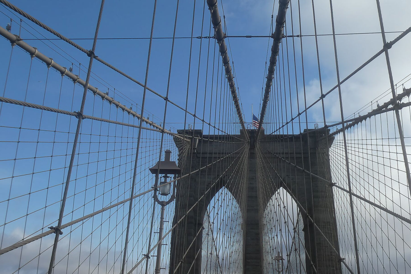 Brooklyn Bridge between blue sky and dark clouds
